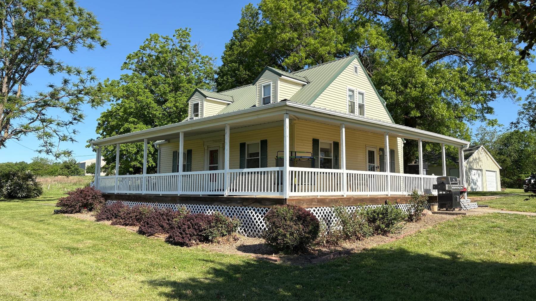 Country home with a wraparound porch on acreage in northwest Missouri