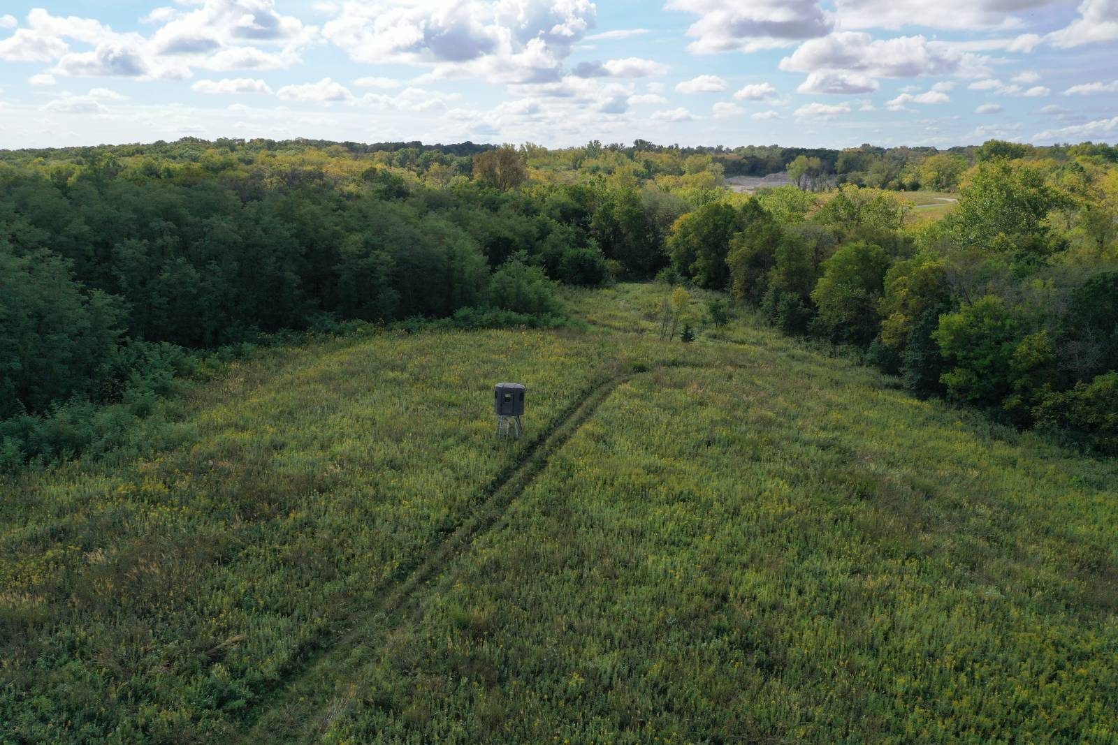 Aerial view of Harrison County, Missouri land with a box blind in a green food plot