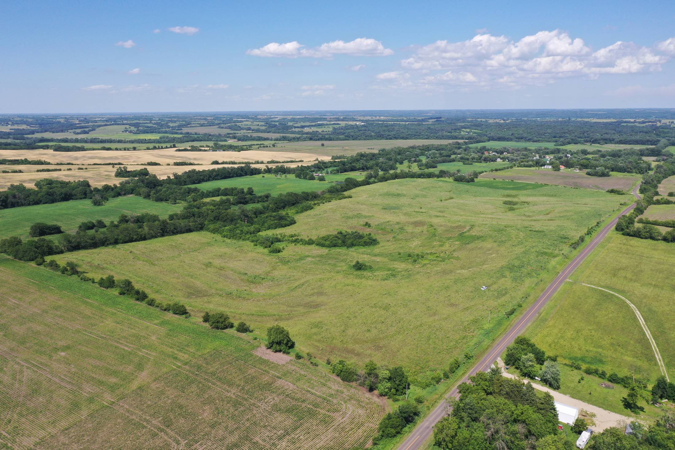 Aerial view of a northwest Missouri land tract with timber and crop ground